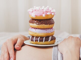 Donuts on the Pregnant woman’s belly.
