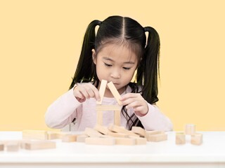 young little cute asian girl build a house