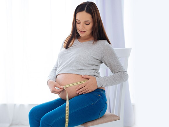 Pregnant woman measuring 
