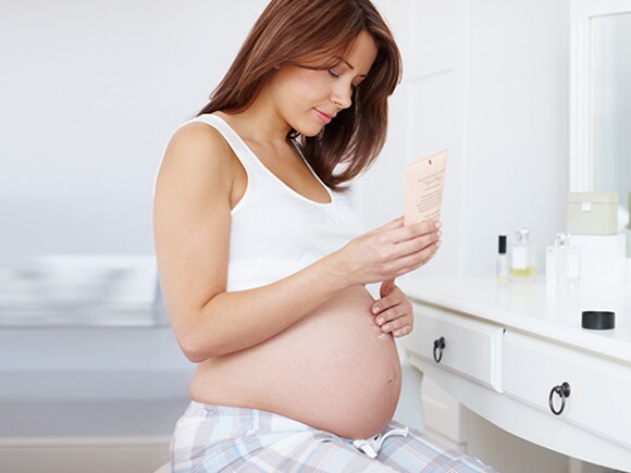 Pregnant woman using skin care