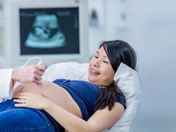 Pregnant woman getting ultrasound from doctor.